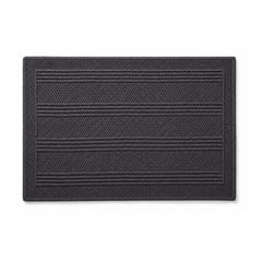 Charcoal woven bath mat with linear texture on white background