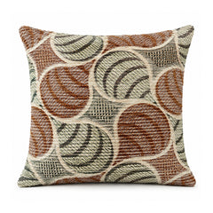 Primeval cinnamon rust olive and cream cushion featuring overlapping circular swirls and retro-style arcs