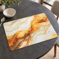 Rectangular placemat with cream, amber and golden marble swirl pattern on a dining table