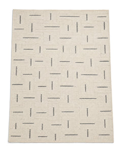 Cream and charcoal handwoven area rug with broken-line dash pattern on a white background.