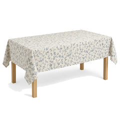 Primeval cream dusty blue vine print tablecloth displayed on a rectangular dining table
