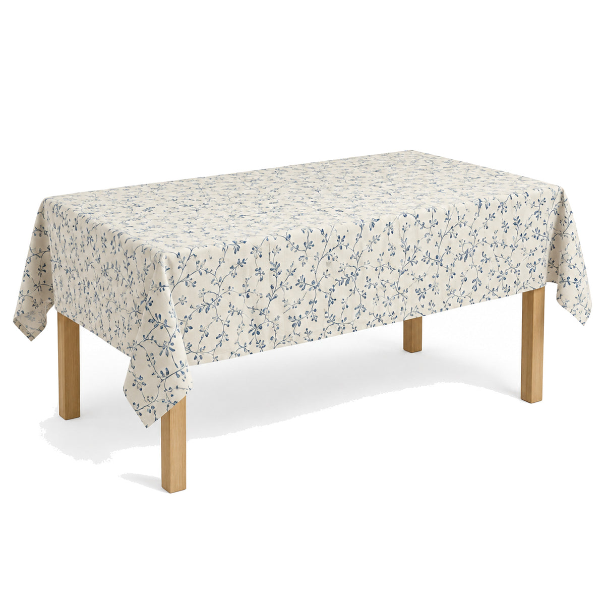Primeval cream dusty blue vine print tablecloth displayed on a rectangular dining table