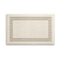 Cream cotton bath mat with Greek key border on white background