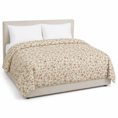 Primeval cream muted rose sage artisan floral duvet cover displayed on a styled bed against a clean white studio background