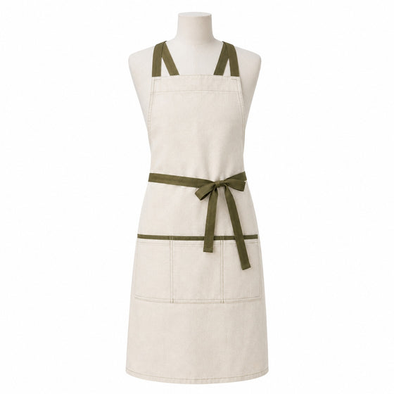 Primeval cream chef apron with olive cross-back straps and front pockets displayed on a dress form