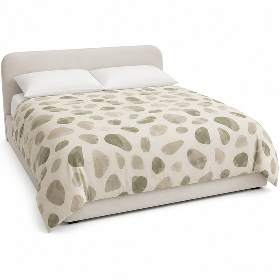 Primeval cream olive and taupe pebble duvet cover displayed on a styled bed against a clean white studio background