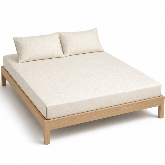 Cream organic contour-pattern bed sheet set with matching pillowcases on a wooden bed