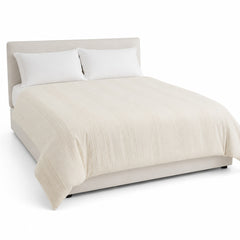 Primeval cream raised stripe duvet cover displayed on a styled bed against a clean white studio background