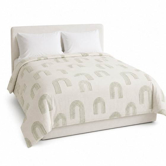 Primeval cream and sage abstract arch duvet cover displayed on a styled bed against a clean white studio background