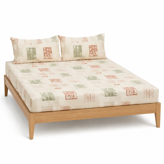 Cream sage and terracotta block-print bed sheet set with matching pillowcases on a wooden bed