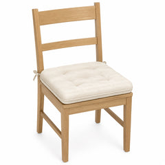 Primeval cream soft tufted dining chair pad with tie straps on wooden dining chair