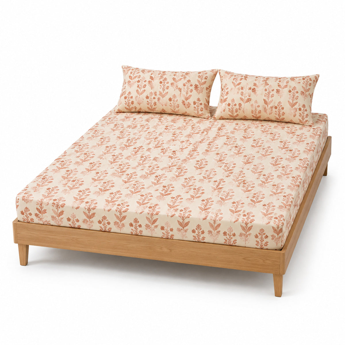 Cream and terracotta block floral bed sheet set with matching pillowcases on a wooden bed