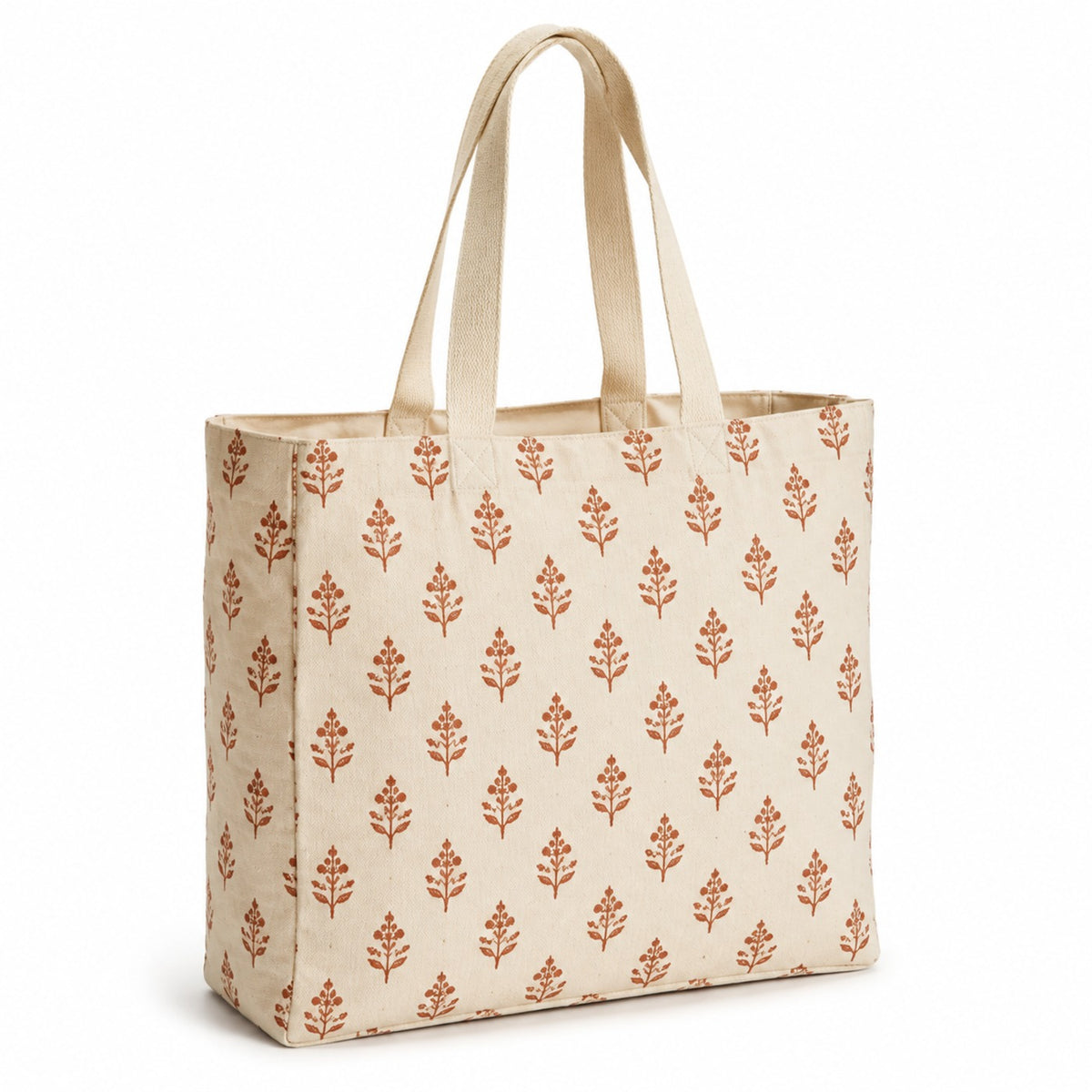 Cream tote bag with terracotta block-printed leaf motifs and natural handles on a white background.