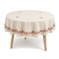 Primeval cream terracotta floral embroidery tablecloth displayed on a round dining table