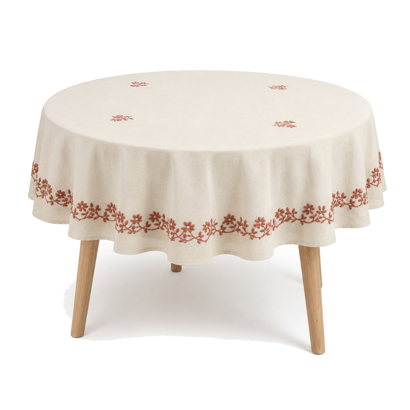 Primeval cream terracotta floral embroidery tablecloth displayed on a round dining table