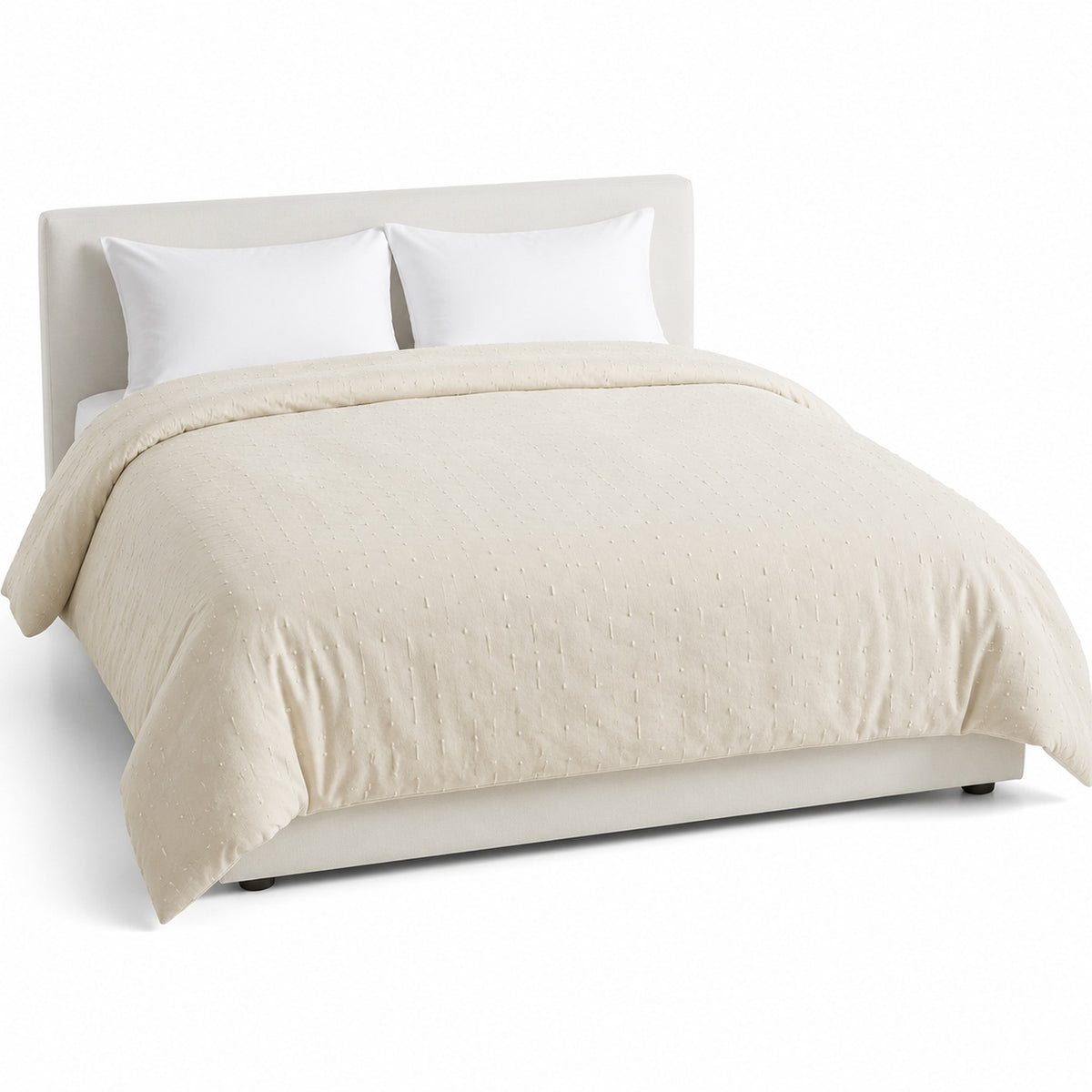 Primeval cream textured finish duvet cover displayed on a styled bed against a clean white studio background