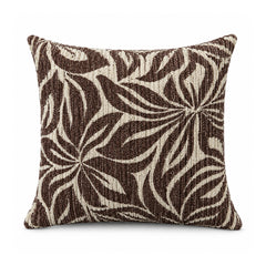 Primeval decorative throw cushion with dark chocolate brown and ivory overlapping botanical leaves, shown against a white background