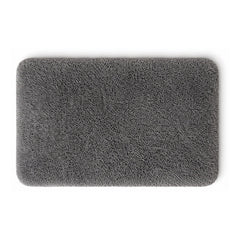 Dark grey plush shag bath mat with rounded corners on white background
