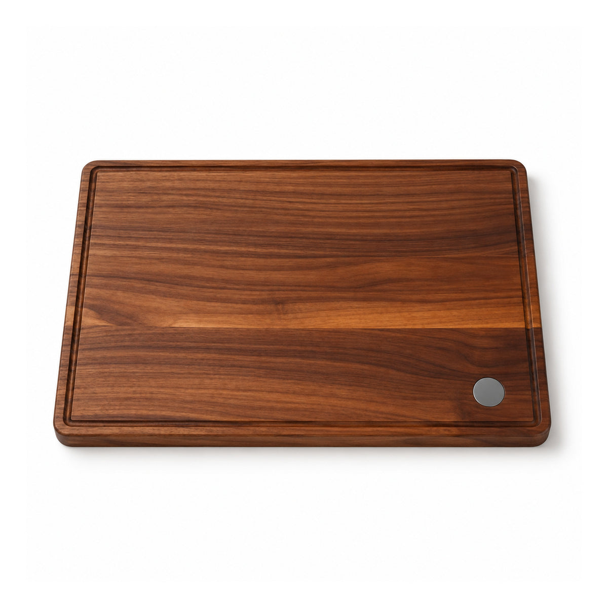 Dark walnut-tone rectangular wooden cutting board with warm horizontal grain, softly beveled edges and a small circular grey corner accent