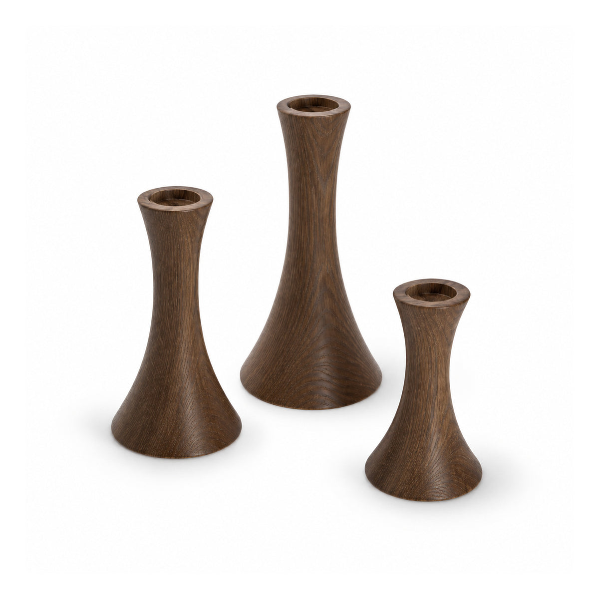 Three slender dark espresso-brown wooden candle holders of different heights with flared hourglass silhouettes and empty top sockets