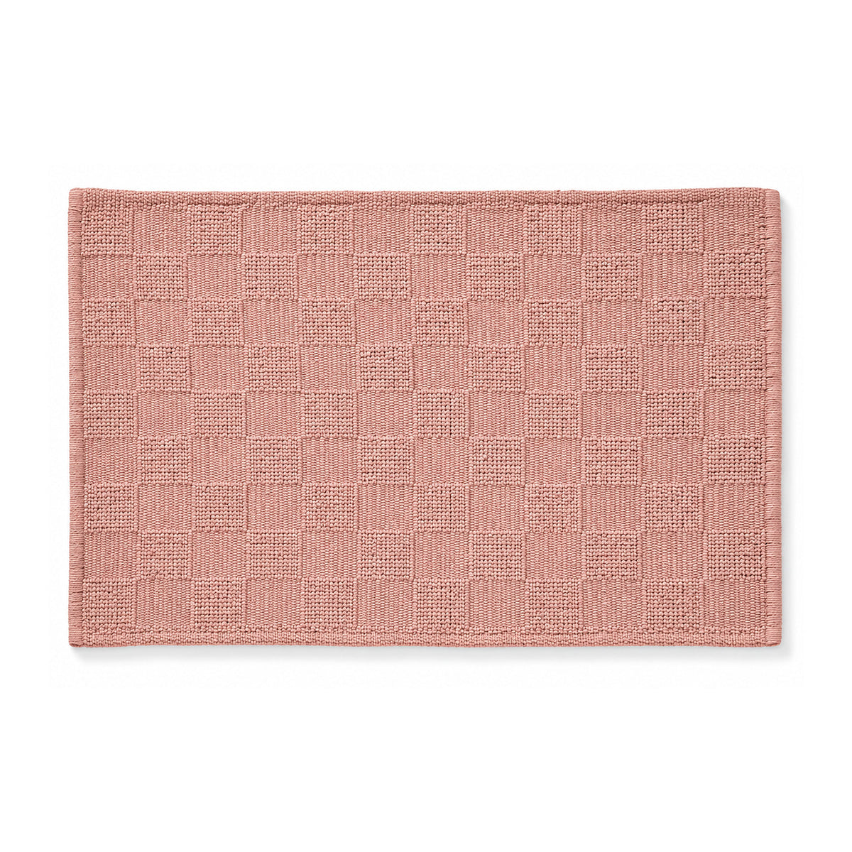 Dusty rose woven checkerboard bath mat on white background