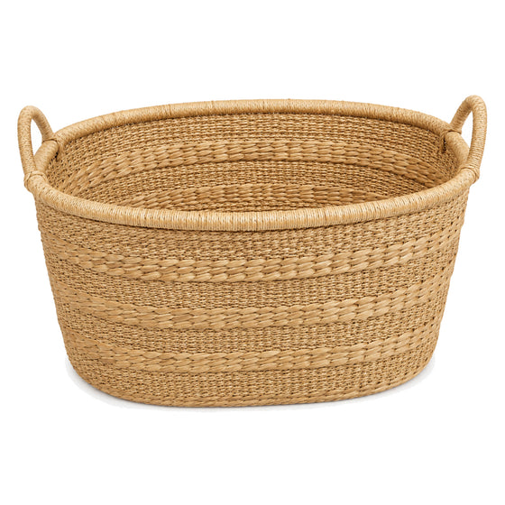 Family size oval natural fibre laundry basket on a clean white background