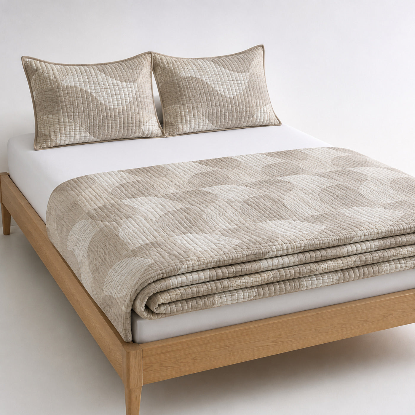 Greige and cream wave check cotton quilt, folded with matching pillows for wholesale bedding sourcing