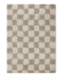 Greige and ivory shaggy area rug with a soft checkerboard pattern on a white background.