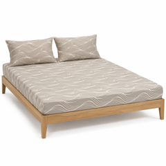 Greige and ivory flowing wave-line bed sheet set with matching pillowcases on a wooden bed