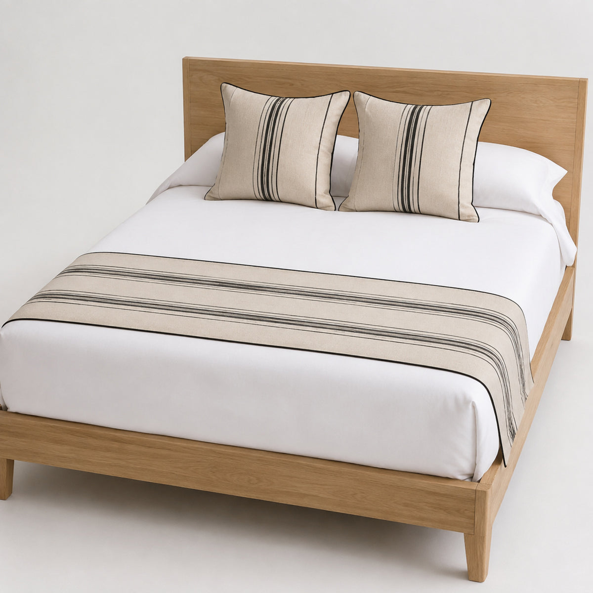 Greige linear stripe bed runner styled on white bedding for wholesale hospitality and contemporary bedroom collections