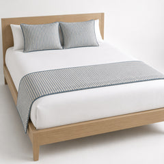 Grey fine-weave bed runner styled across white bedding for wholesale hotel, hospitality and private-label bedroom sourcing