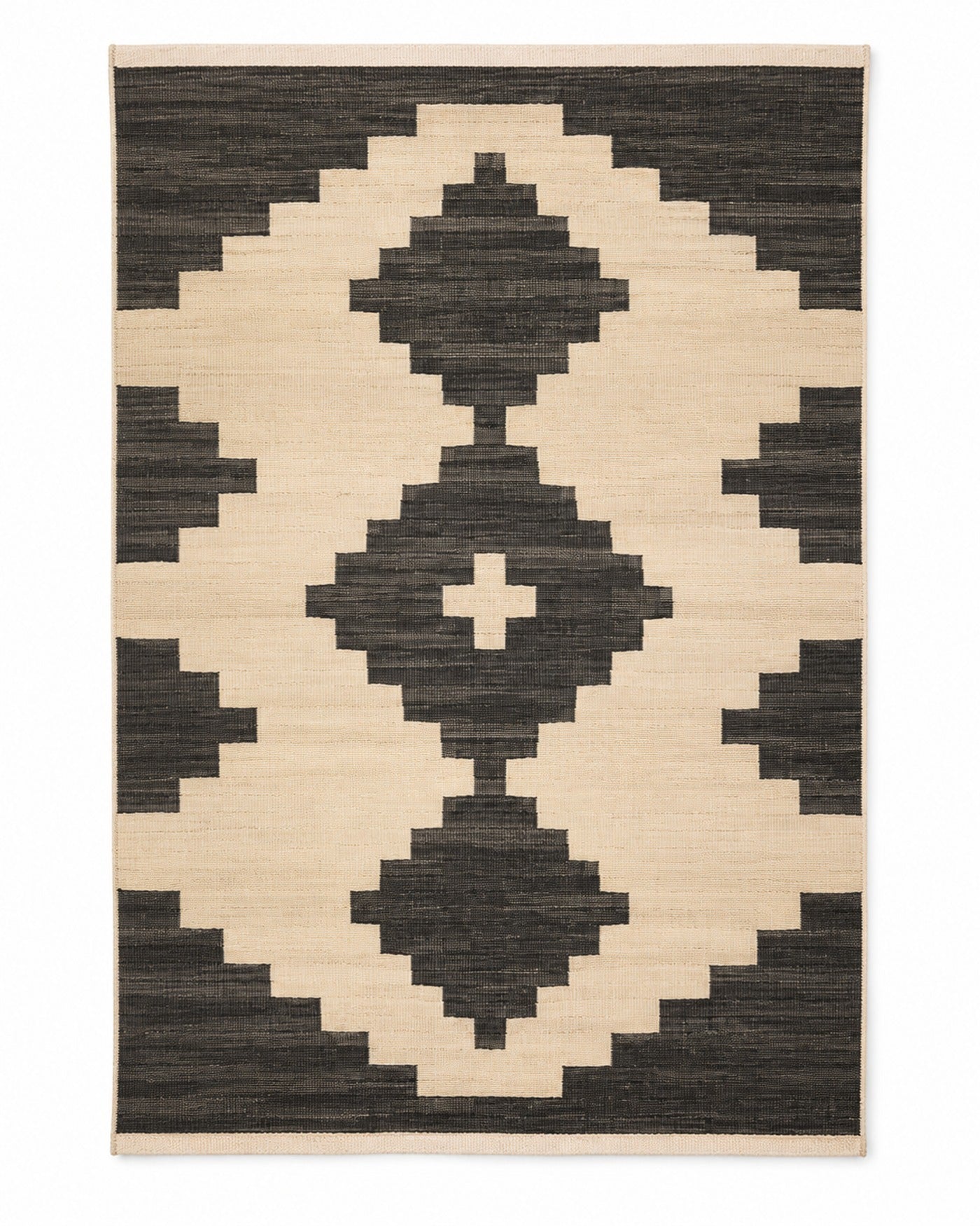 Black and ivory handwoven cotton rug with bold tribal geometric motif