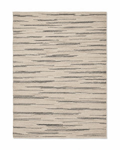 Black and ivory handwoven cotton rug with abstract broken horizontal stripes