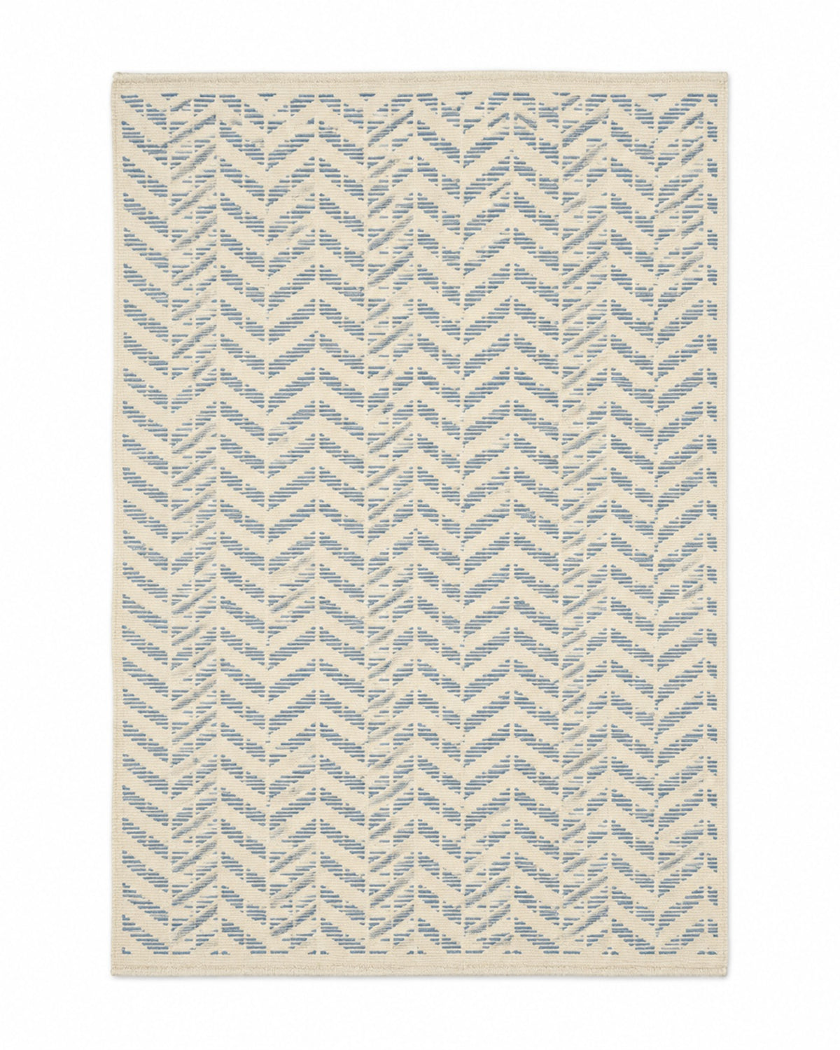 Blue and ivory handwoven cotton rug with small herringbone chevron repeat
