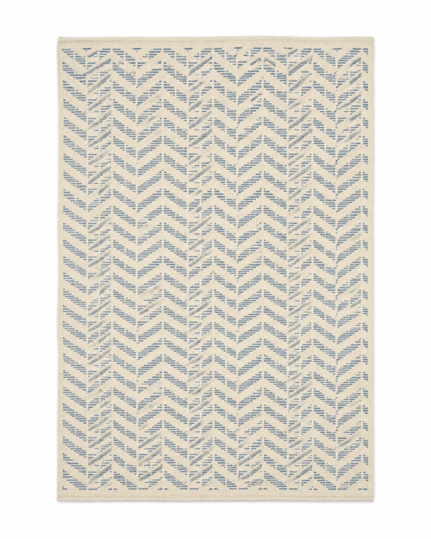 Blue and ivory handwoven cotton rug with small herringbone chevron repeat