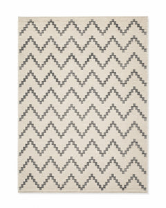 Charcoal and ivory handwoven cotton rug with repeating chevron pattern