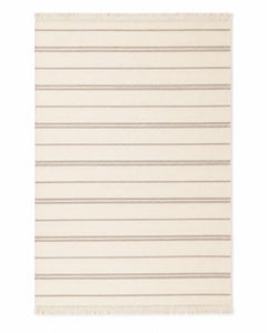 Ivory and taupe handwoven cotton rug with fine horizontal stripes and fringe