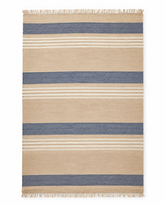 Navy and beige handwoven cotton rug with wide horizontal stripes and fringe