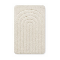 Ivory arch tufted bath mat on white background