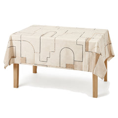 Primeval ivory black camel architectural line tablecloth displayed on a rectangular dining table