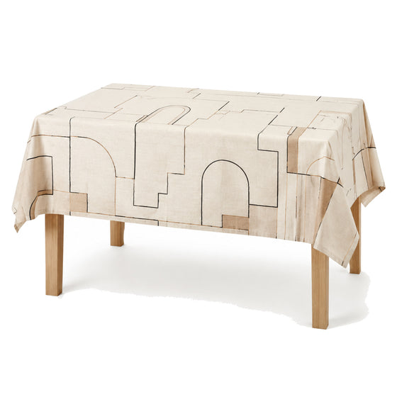 Primeval ivory black camel architectural line tablecloth displayed on a rectangular dining table