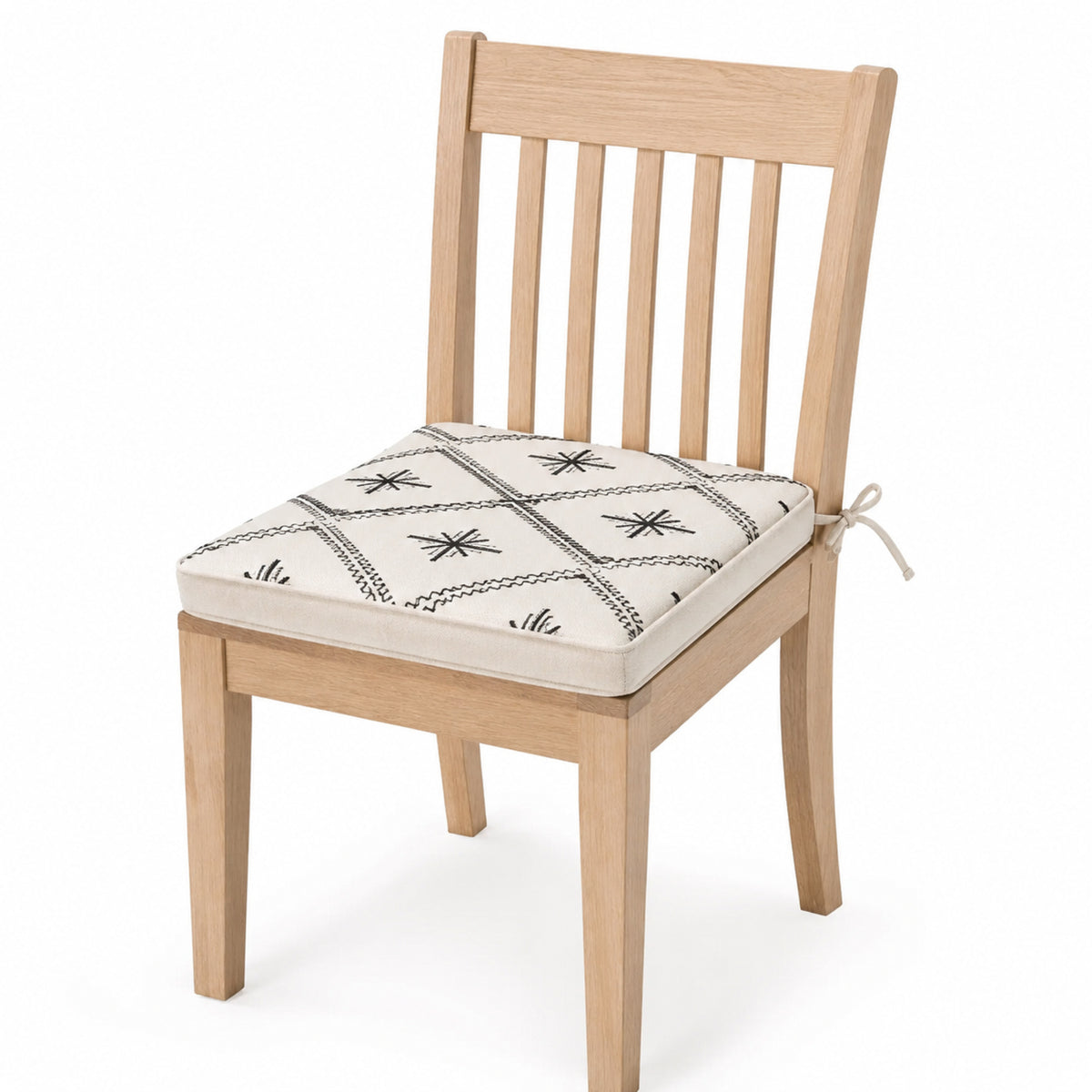 Primeval ivory and black folk motif dining chair pad with tie straps on wooden dining chair