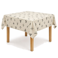 Primeval ivory black Scandinavian geometric print tablecloth displayed on a square dining table