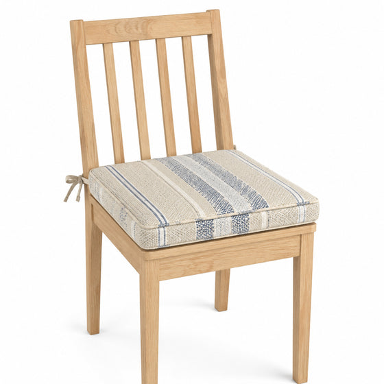 Primeval ivory and blue woven stripe dining chair pad with tie straps on wooden dining chair