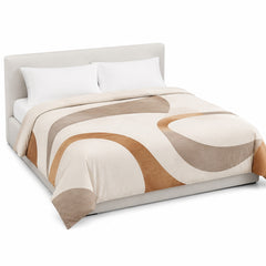Primeval ivory caramel and taupe curved-form duvet cover displayed on a styled bed against a clean white studio background