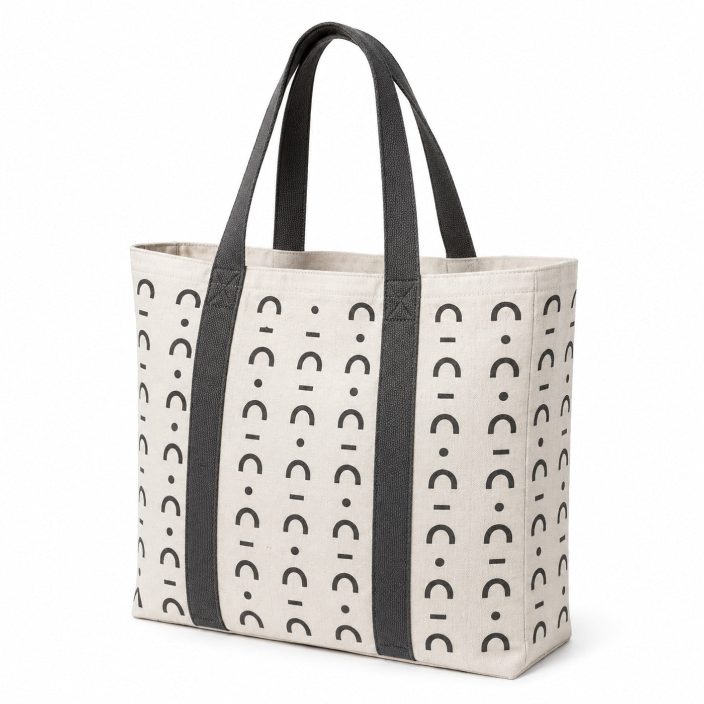 Ivory tote bag with charcoal Scandinavian-inspired abstract print and dark handles on a white background.