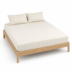 Ivory and charcoal thin-grid bed sheet set with matching pillowcases on a wooden bed