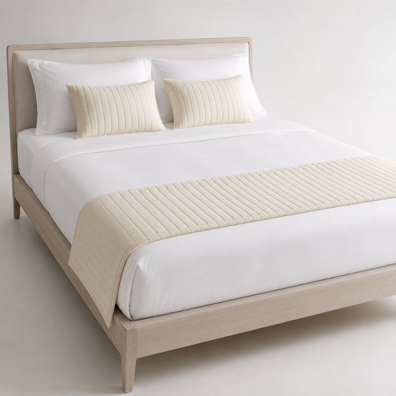 Ivory diamond-quilted bed runner styled on white bedding for wholesale hotel, resort and private-label bedroom sourcing