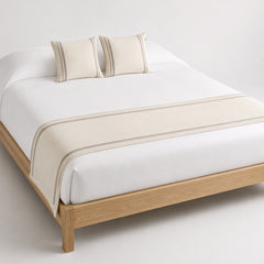 Ivory minimalist bed runner with double-line border, styled on a white bed for wholesale hospitality and home textile sourcing