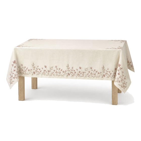 Primeval ivory dusty rose taupe botanical embroidery tablecloth displayed on a rectangular dining table